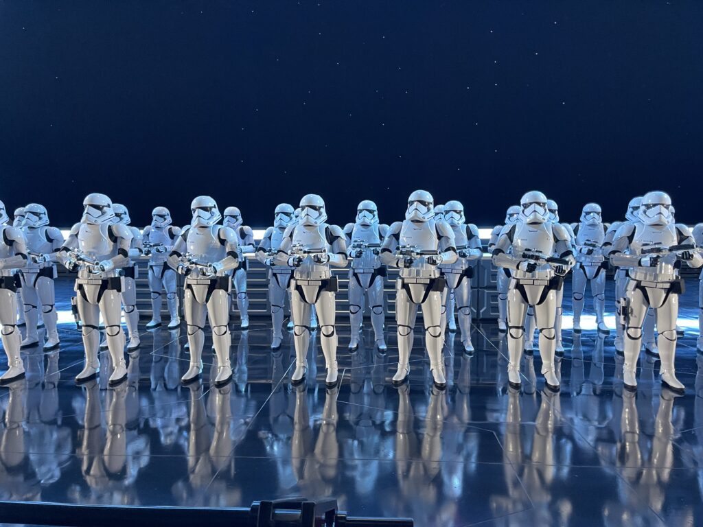 stormtroopers lined up at beginning of rise of the resistance ride
can see galaxy behind them