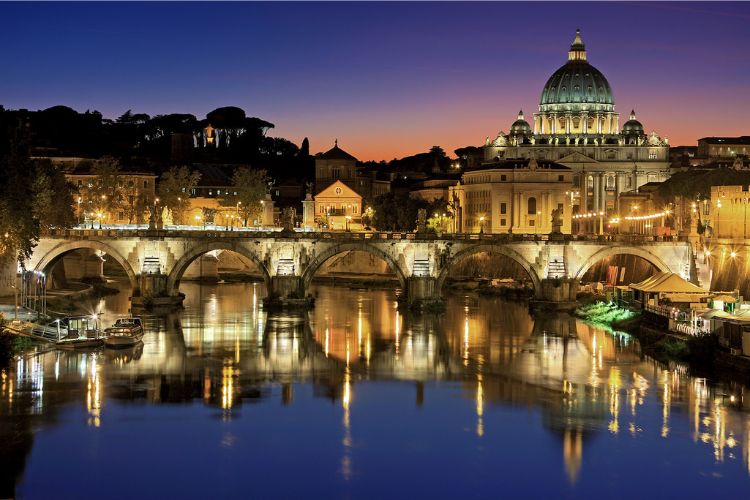 the eternal city at night, bridge over canal and roman city in background