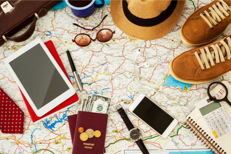 map, travel bag, sun hat, sneakers, sunglasses, tablet, money, travel documents,  journal , calculator, watch