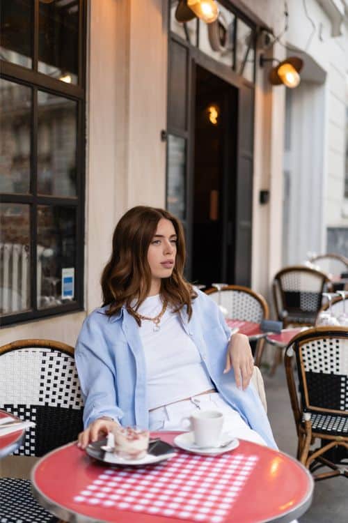 french woman sitting at outdoor cafe