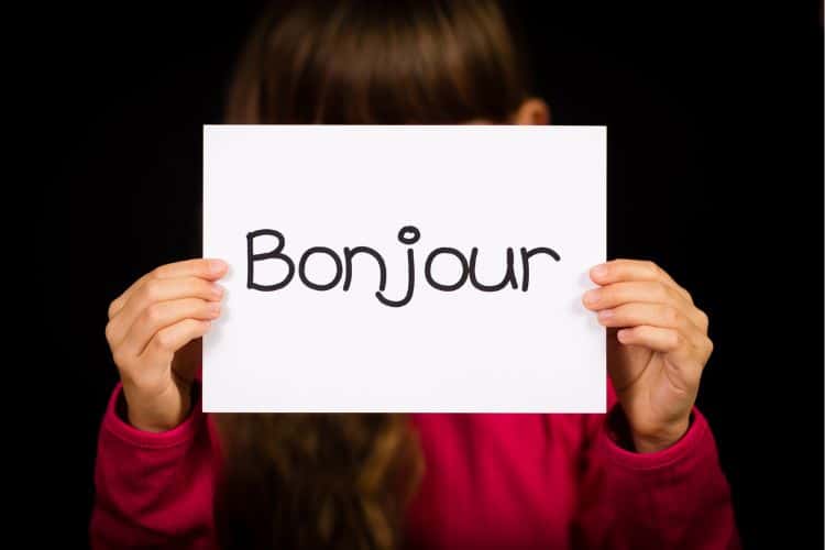 how to say hello in french, girl holding bonjour slide