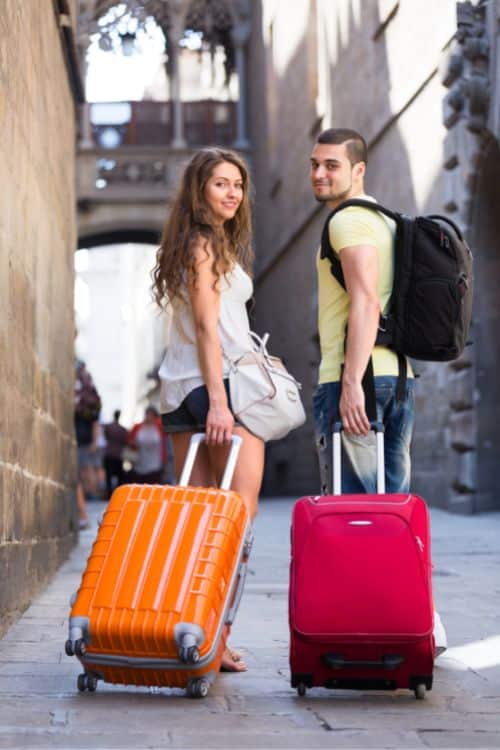 two travelers with their packed bags