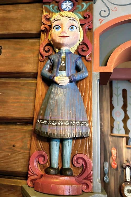 A carved wooden figure of young Elsa
